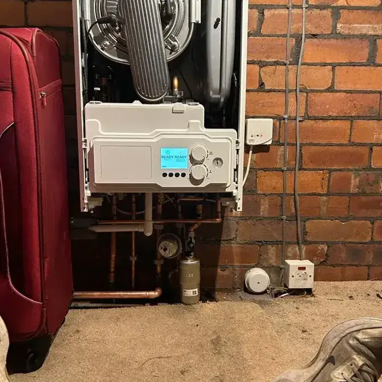 there is a red suitcase and a red suitcase next to a wall