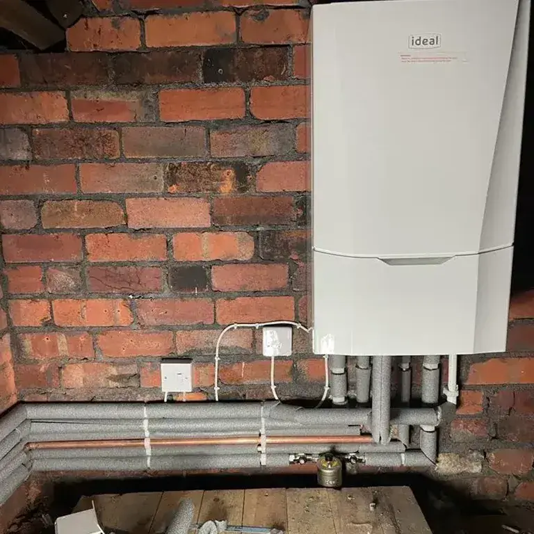 there is a tankless water heater in a room with pipes