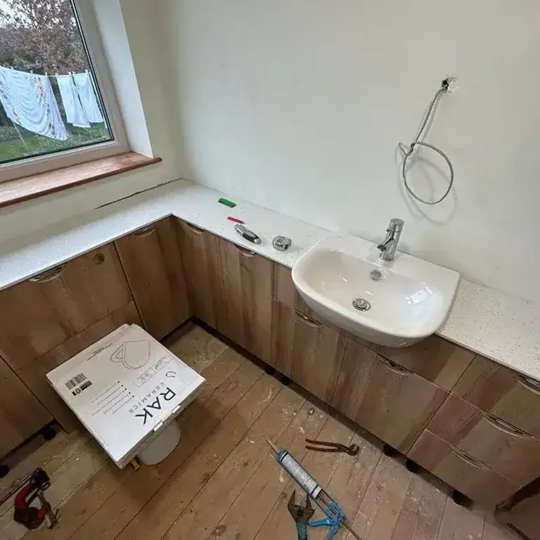 bathroom with a sink and a window in it