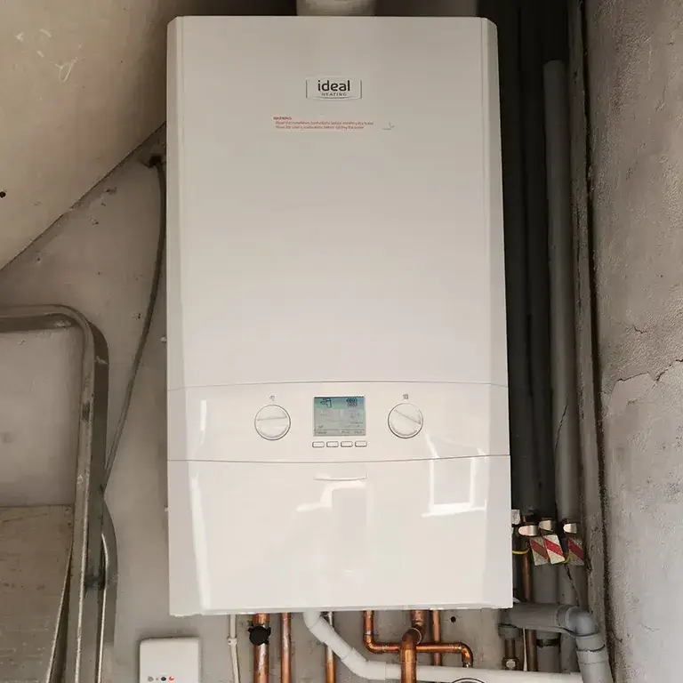 a close up of a tank type water heater with pipes and pipes