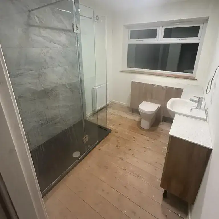 there is a bathroom with a toilet, sink, and shower in it