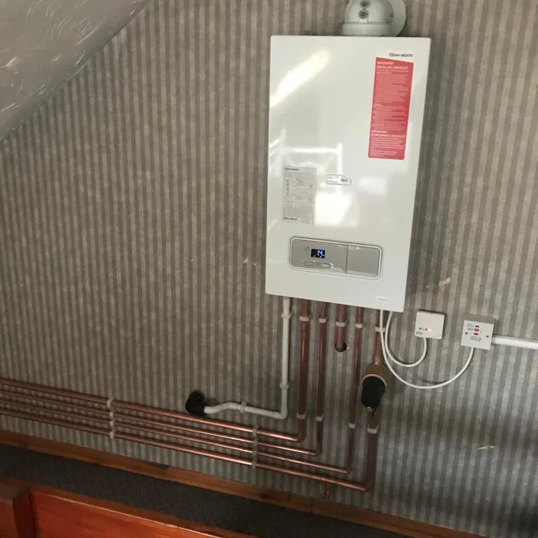 a white tank mounted to the side of a wall