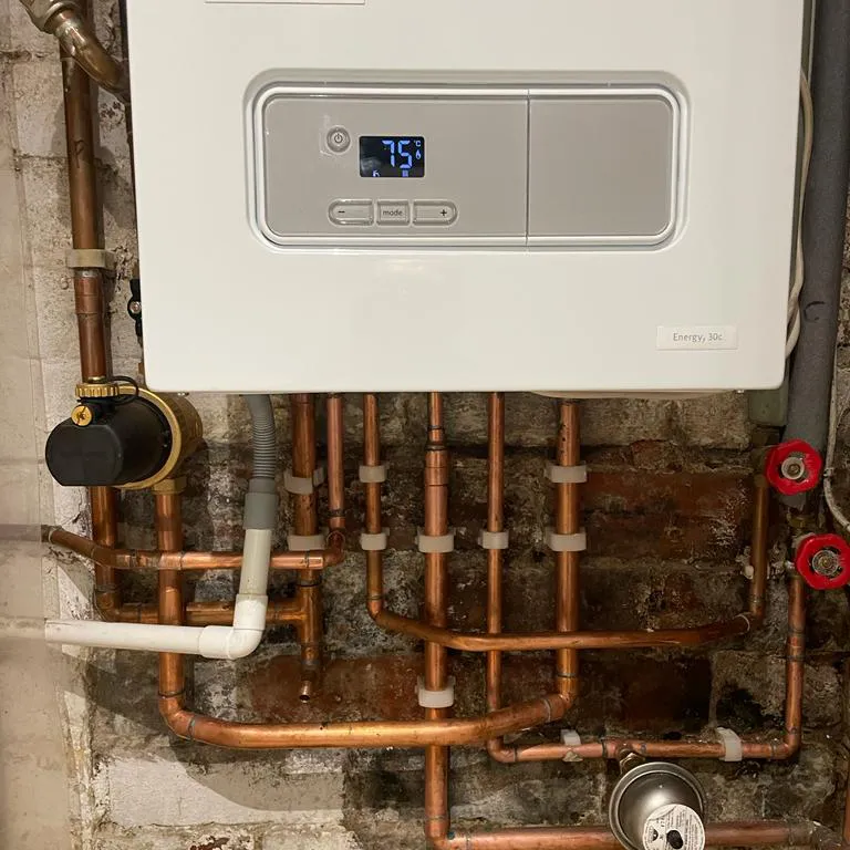 a tankless water heater with pipes and a timer