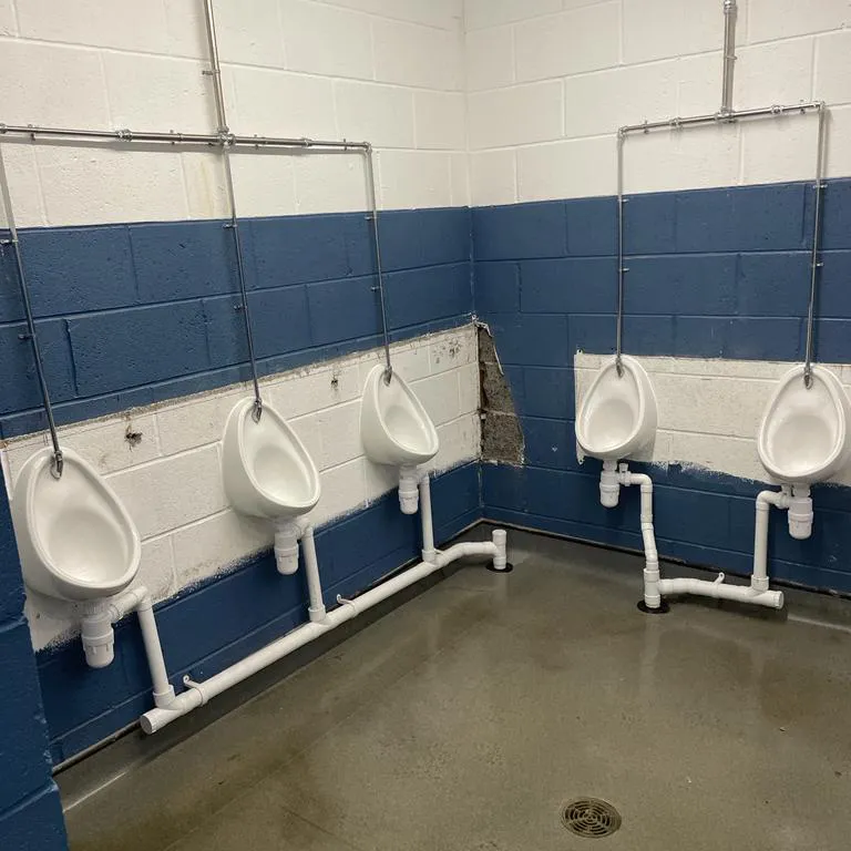 a row of urinals in a men's bathroom