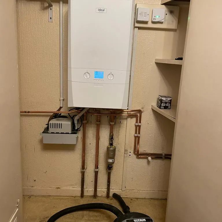 a tankless water heater sitting in a corner of a room
