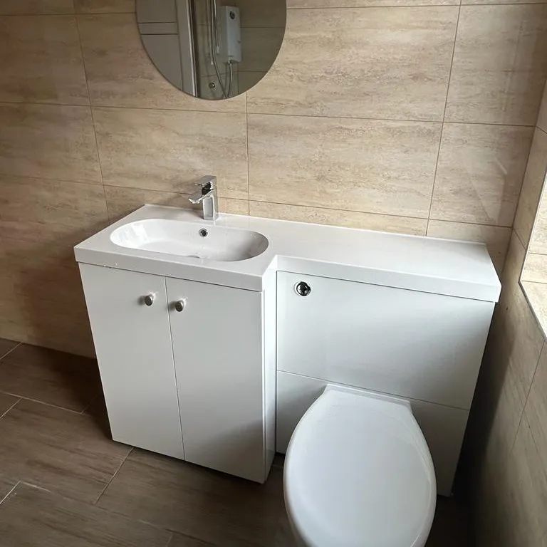 a white toilet sitting next to a white sink